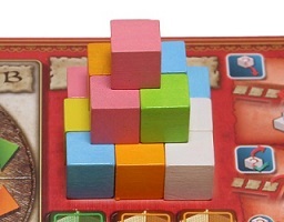 closeup of a stack of multicolored cube-shaped game pieces on the game board