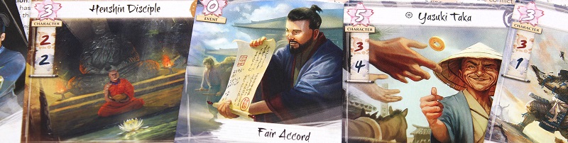closeup of several cards' illustrations, including a buddhist monk meditating, a man opening a scroll, and a man flicking a coin into an unseen person's outspread hands