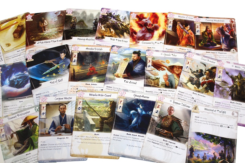 numerous game cards laid out face up, showing many different colorful illustrations depicting many characters/examples of game play instructions