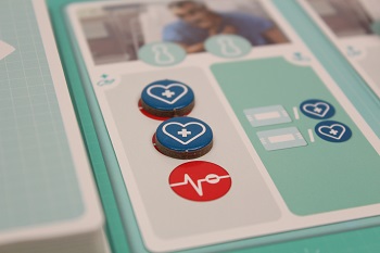 closeup of the game board with several blue tokens placed upon it