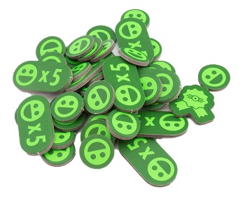 A pile of cardboard tokens featuring a stylized smiling face.