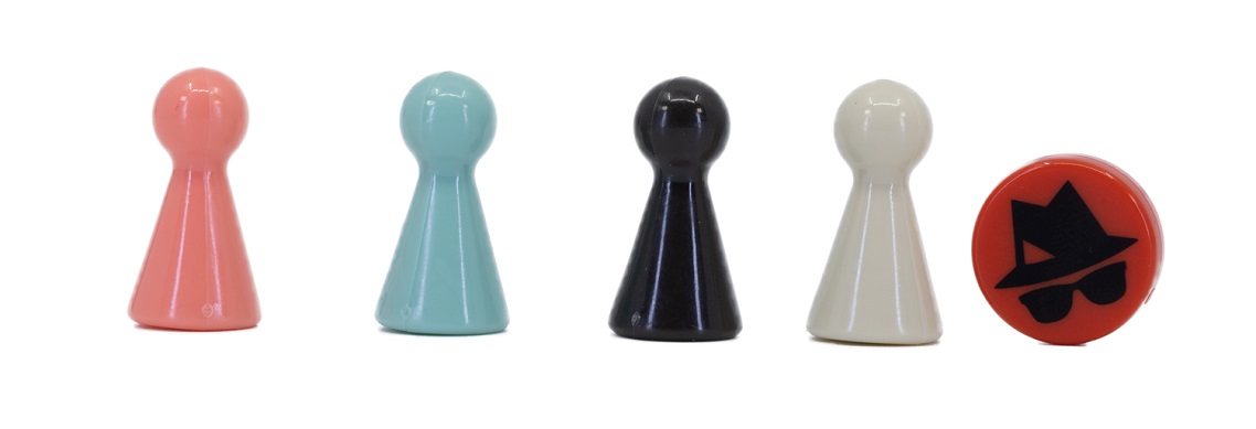 A row of four wooden pawns in different colors and a small plastic disc with the face of a spy